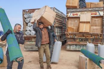 After the 2023 earthquake, prosper global distributed kits for families at camps for displaced people in northwest syria. the kits included mattresses, blankets, solar lamps, rugs, and more.