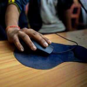 A hand holding a computer mouse.