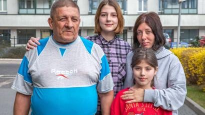 Anjela stands with her father and two daughters. After fleeing their home in Kharkiv, Ukraine, they found shelter in Poland through a Prosper Global partner organization.